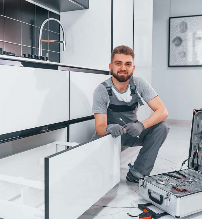 young-professional-plumber-in-grey-uniform-using-e-resize.jpg